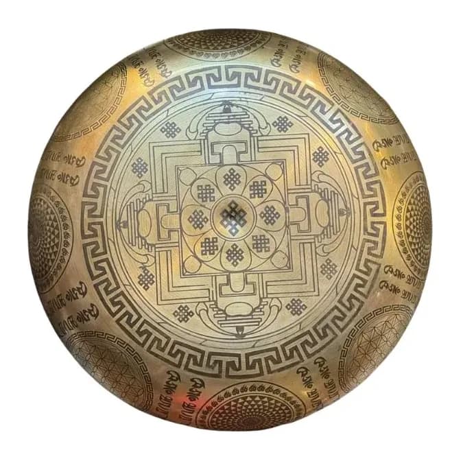 A machine-finished singing bowl etched with a seven-chakra mandala, viewed from above