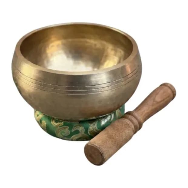 A machine-finished singing bowl etched with a seven-chakra mandala, viewed from above